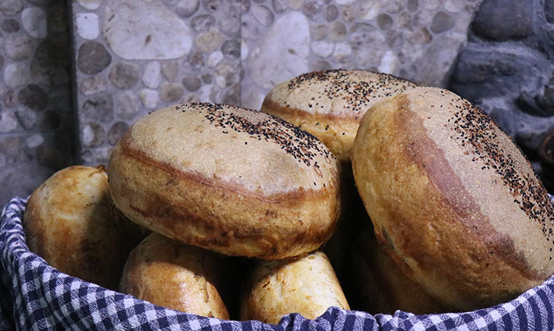 Topladığı taşlarla ekmek üretiyor